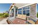 Charming front porch with comfortable seating area and stylish exterior stone accents at 12604 Madison Way, Thornton, CO 80241