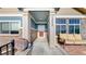 Inviting front porch with ample seating and beautiful stone detailing at 12604 Madison Way, Thornton, CO 80241