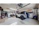 Spacious garage with epoxy flooring and plenty of storage, including overhead racks at 12604 Madison Way, Thornton, CO 80241