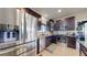 Stainless appliances adorn this modern kitchen, with granite countertops and dark cabinetry adding elegance at 12604 Madison Way, Thornton, CO 80241