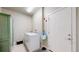 Laundry room featuring modern appliances, ample storage, and access to the exterior at 12604 Madison Way, Thornton, CO 80241