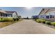 A wide street view showing multiple similar homes in a well-maintained community at 12604 Madison Way, Thornton, CO 80241