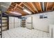 Unfinished basement features exposed ductwork, large storage cabinets and neutral flooring at 7382 E Bates Dr, Denver, CO 80231