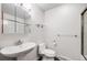Bright bathroom featuring a white sink, toilet, and glass-enclosed shower at 7382 E Bates Dr, Denver, CO 80231