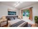This bedroom offers great natural light, and is complete with a stylish bed and contemporary decor at 7382 E Bates Dr, Denver, CO 80231