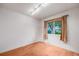 Cozy bedroom featuring hardwood floors, natural light, and a minimalist aesthetic at 7382 E Bates Dr, Denver, CO 80231