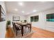 Dining room features hardwood floors, a neutral rug, and great natural light at 7382 E Bates Dr, Denver, CO 80231
