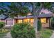 Attractive home with mature landscaping, lush green bushes, and a picturesque curb appeal at 7382 E Bates Dr, Denver, CO 80231