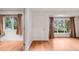 Open living area with gleaming hardwood floors, large windows, and neutral decor at 7382 E Bates Dr, Denver, CO 80231