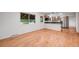 An open floor plan offering hardwood floors and natural light leading to the kitchen at 7382 E Bates Dr, Denver, CO 80231