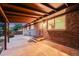 View of covered back patio showcasing brick exterior and access to the house at 7382 E Bates Dr, Denver, CO 80231