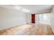 Large room with tile floors and access to other rooms at 7382 E Bates Dr, Denver, CO 80231