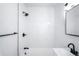 Modern bathroom featuring black fixtures, a subway tiled shower and bright lighting at 1168 Kearney St, Denver, CO 80220