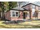 Charming brick home featuring professionally landscaped front yard and stylish black shutters at 1168 Kearney St, Denver, CO 80220
