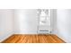 Cozy living room featuring gleaming hardwood floors, a bright window, and neutral paint throughout at 1168 Kearney St, Denver, CO 80220
