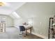 Well-lit attic room features a desk area and a window, offering a bright and functional workspace at 3051 W 39Th Ave, Denver, CO 80211