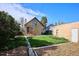 Landscaped backyard with a lush lawn, charming home exterior, and detached brick building at 3051 W 39Th Ave, Denver, CO 80211