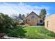 Backyard featuring a grassy area, deck with stairs, wood exterior of the home and detached brick building at 3051 W 39Th Ave, Denver, CO 80211