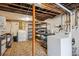 Functional basement laundry area equipped with washer, dryer, storage shelves, and a durable rug at 3051 W 39Th Ave, Denver, CO 80211