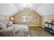 Bright bedroom featuring sloped ceilings, natural light, and neutral color scheme at 3051 W 39Th Ave, Denver, CO 80211