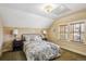 Cozy bedroom featuring neutral walls, two bedside tables, a window, and a comfortable bed with stylish paisley patterned linens at 3051 W 39Th Ave, Denver, CO 80211