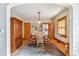 A dining area features an area rug, wood trim, and an open connection to the kitchen at 3051 W 39Th Ave, Denver, CO 80211