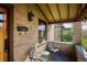Relax on the inviting front porch with brick detail and cozy seating at 3051 W 39Th Ave, Denver, CO 80211