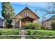 Charming home featuring a well-manicured lawn, brick accents, and inviting front porch at 3051 W 39Th Ave, Denver, CO 80211