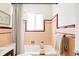 Charming bathroom featuring a soaking tub, pink tiles and a window for natural light at 4420 W 27Th Ave, Denver, CO 80212