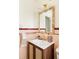 Bathroom featuring stylish mirror and sink, with pink tiles and modern lighting at 4420 W 27Th Ave, Denver, CO 80212