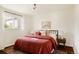 Comfortable bedroom featuring a queen-size bed with stylish linens and a sun-filled window at 4420 W 27Th Ave, Denver, CO 80212