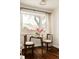 Cozy dining area featuring a round table, bay windows, and hardwood flooring at 4420 W 27Th Ave, Denver, CO 80212