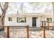 Charming home with a white brick facade, complemented by a stylish front entrance and inviting walkway at 4420 W 27Th Ave, Denver, CO 80212