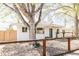 Charming white brick home with a well-maintained gravel yard, new fence, and a mature tree in the front yard at 4420 W 27Th Ave, Denver, CO 80212