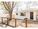 White brick home with a well-maintained gravel yard, new fence, and mature trees at 4420 W 27Th Ave, Denver, CO 80212