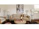 Neutral-toned living room with a textured sofa, modern art, and elegant lighting fixtures at 4420 W 27Th Ave, Denver, CO 80212