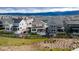 An aerial view showcasing the property's backyard, patio area, and surrounding neighborhood with mountain views at 8939 Bellsong Cir, Littleton, CO 80125