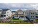Expansive backyard view of the property featuring a covered patio, lush lawn, and attractive landscaping at 8939 Bellsong Cir, Littleton, CO 80125