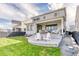 Spacious backyard featuring well-maintained lawn, covered patio, ideal for outdoor enjoyment at 8939 Bellsong Cir, Littleton, CO 80125