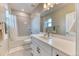 Bright bathroom with tub-shower combo, single vanity, and modern finishes at 8939 Bellsong Cir, Littleton, CO 80125
