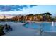 Community pool area featuring a modern design, water features, lounge chairs, and attractive landscaping at 8939 Bellsong Cir, Littleton, CO 80125