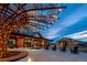 Community gathering space with unique architecture, outdoor seating, and decorative lighting for evening ambiance at 8939 Bellsong Cir, Littleton, CO 80125
