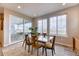 Bright dining area with sliding glass door to the patio and three large windows for ample natural light at 8939 Bellsong Cir, Littleton, CO 80125