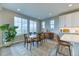Sunlit dining room features large windows and flows into the kitchen, perfect for Gathering meals at 8939 Bellsong Cir, Littleton, CO 80125