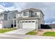 Beautiful two-story home boasting a well-manicured lawn, gray siding, and a convenient two-car attached garage at 8939 Bellsong Cir, Littleton, CO 80125