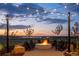 Inviting community fire pit area with comfortable seating, string lights, and scenic sunset views at 8939 Bellsong Cir, Littleton, CO 80125