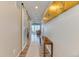 Inviting hallway showcasing wood floors, stylish decor, and a sliding barn door leading to a bright living space at 8939 Bellsong Cir, Littleton, CO 80125
