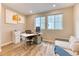Bright home office with natural light, modern desk setup, and a comfortable seating area for versatile use at 8939 Bellsong Cir, Littleton, CO 80125