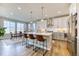 Beautiful kitchen with an island, stainless-steel appliances and a connected dining area with large windows at 8939 Bellsong Cir, Littleton, CO 80125