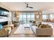 Spacious living room with modern decor, a cozy fireplace, and sliding glass doors offering scenic outdoor views at 8939 Bellsong Cir, Littleton, CO 80125